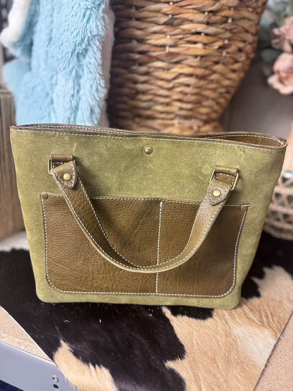 Olive suede daisy bag with salt and pepper hair on hide