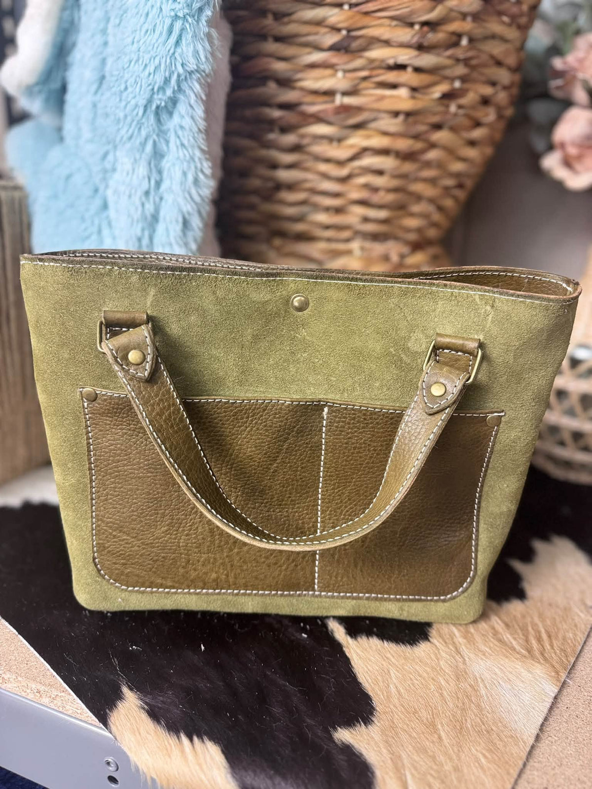 Olive suede daisy bag with salt and pepper hair on hide