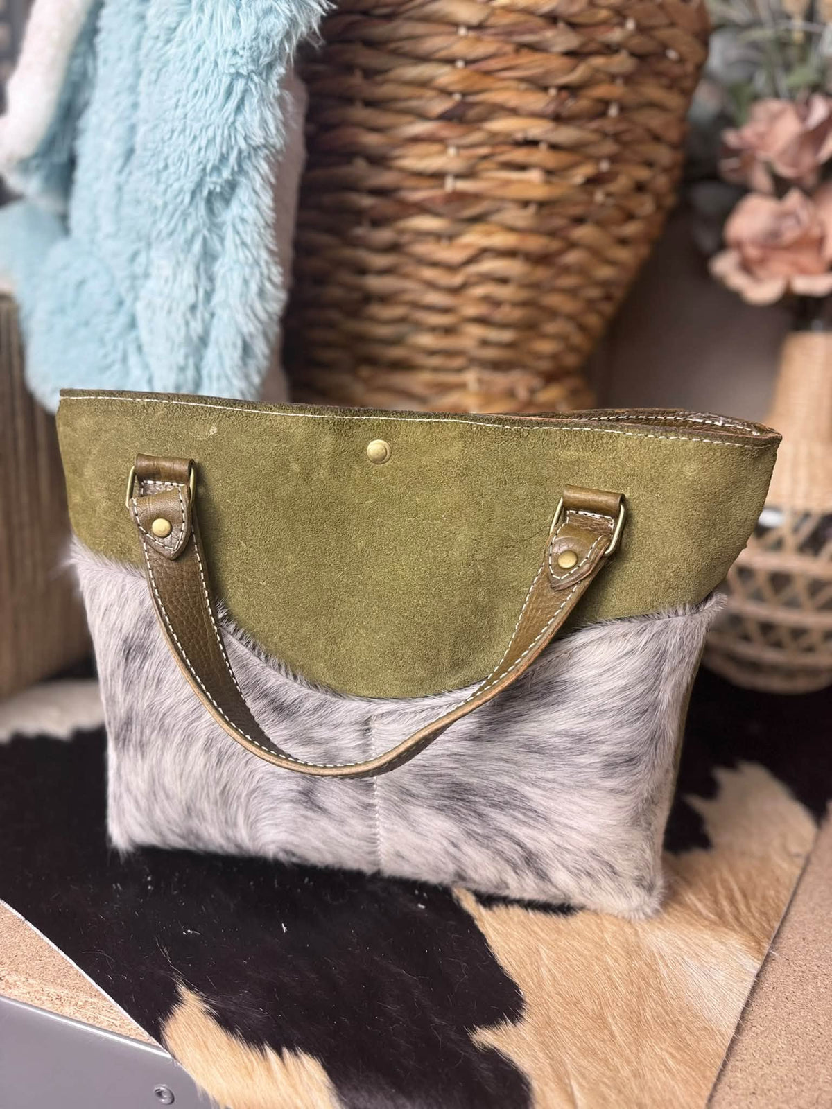 Olive suede daisy bag with salt and pepper hair on hide